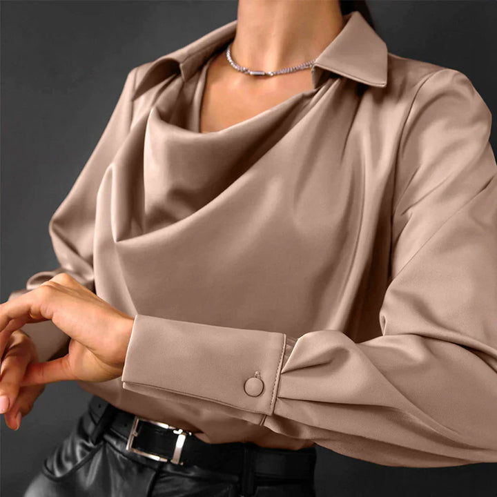 Woman wearing a refined satin top with a smooth finish on a clean background.