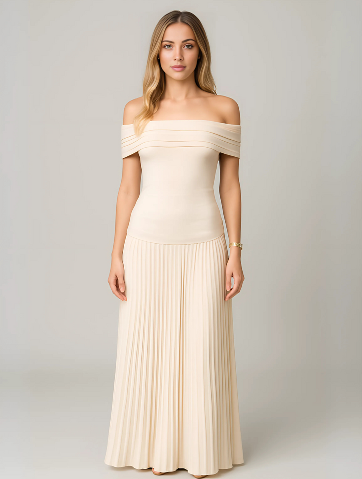 Woman wearing pleated maxi dress on gray background front view.