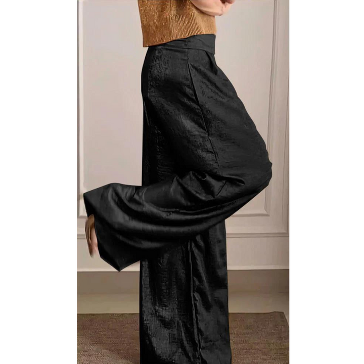 Female model showcasing a relaxed two-piece set with wide-leg trousers against a plain background.