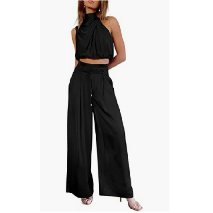 Model in a stylish two-piece outfit with wide-leg trousers on a plain background.