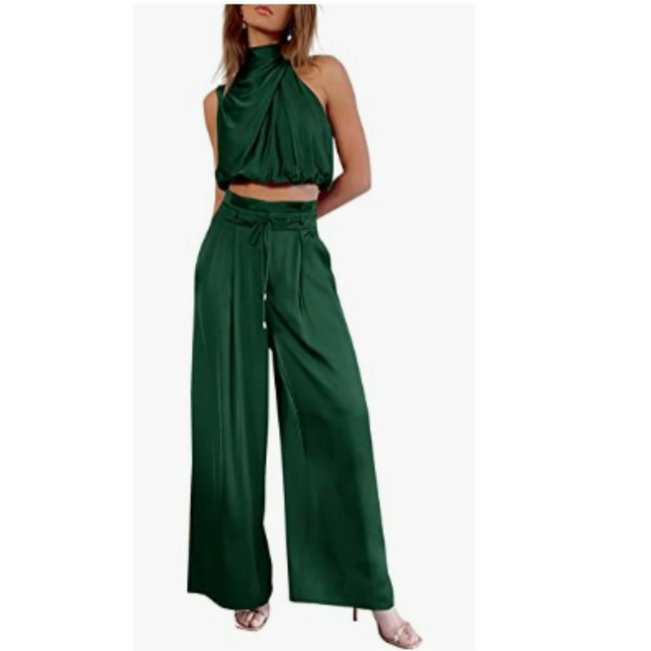 Model presenting a coordinated outfit with a draped top and wide-leg pants on a plain background.