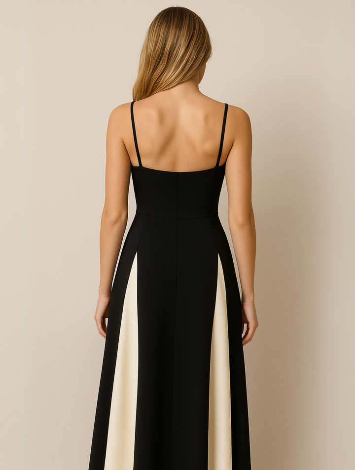Woman in elegant evening dress back view, gray plain background.