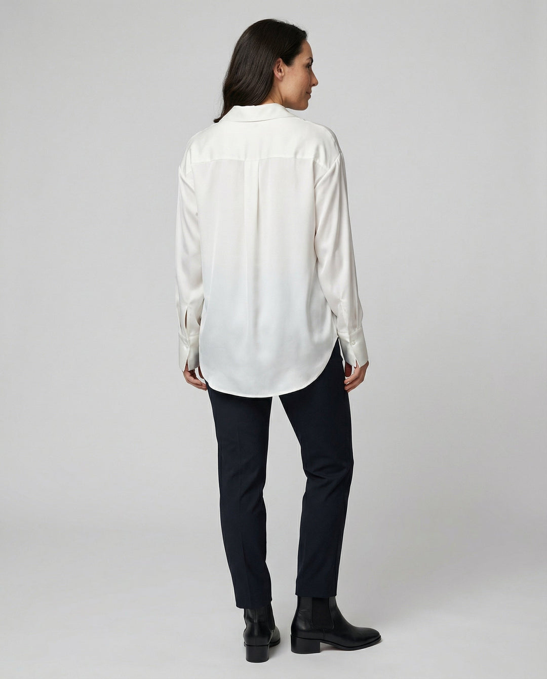 Female model in a lightweight silk blouse styled for formal and casual occasions.