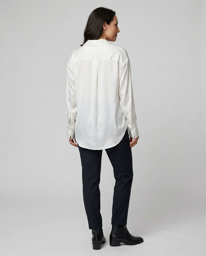 Female model in a lightweight silk blouse styled for formal and casual occasions.