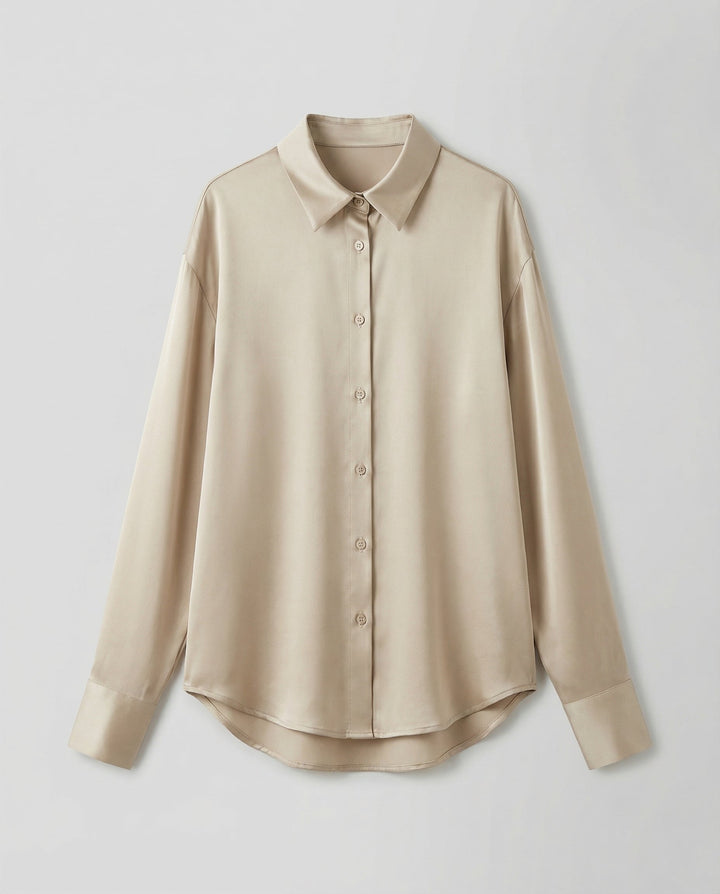 Woman in an elegant silk blouse paired with a refined and polished look.