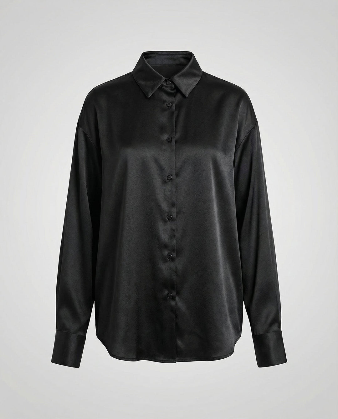 Female model displaying a smooth silk blouse with a timeless silhouette.