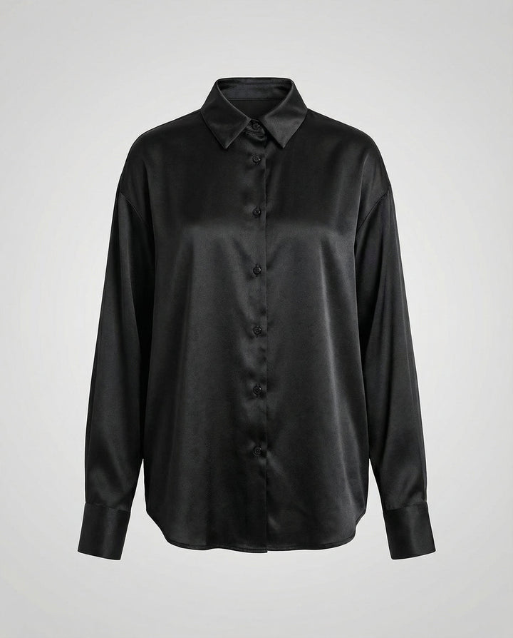 Female model displaying a smooth silk blouse with a timeless silhouette.