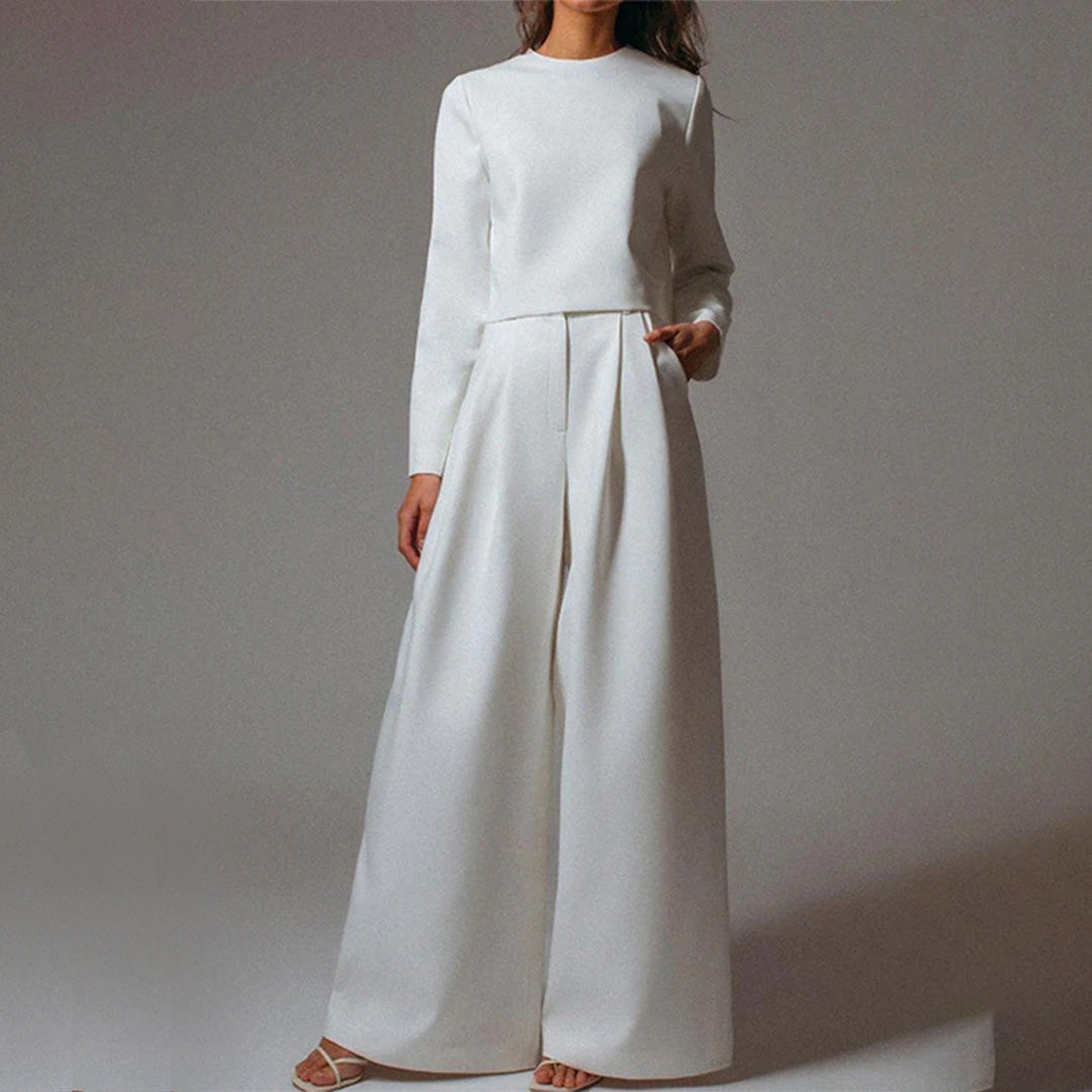 Female model showcasing an effortless two-piece fashion set on a plain background.