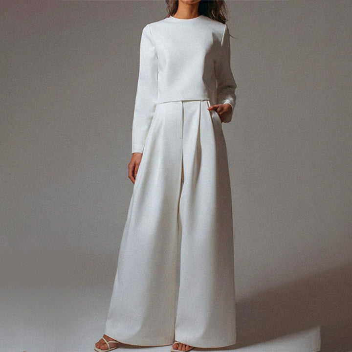 Female model showcasing an effortless two-piece fashion set on a plain background.