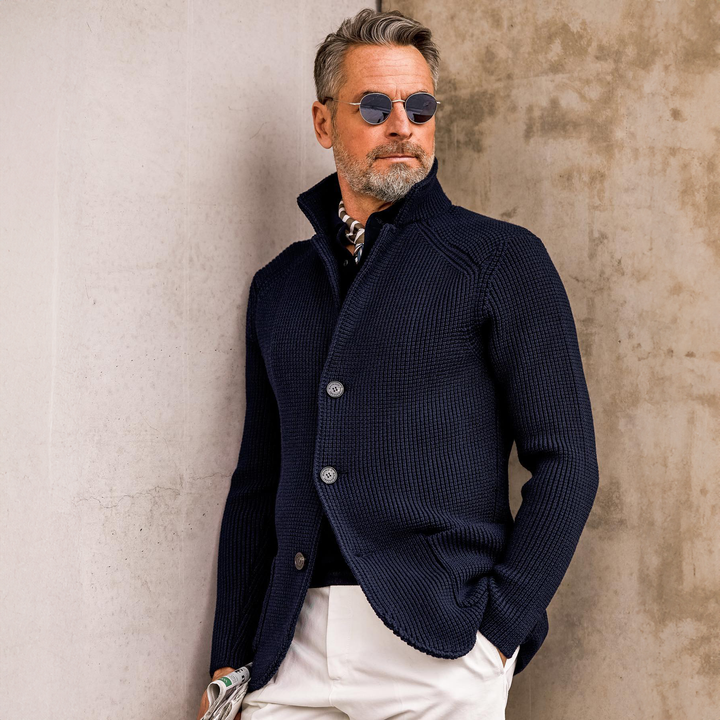  Man presenting a breathable suit outfit for warm-weather styling on a plain background.