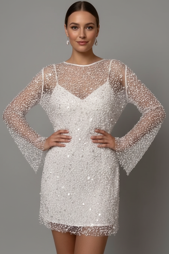 Woman wearing embellished mesh mini dress front view on gray background.