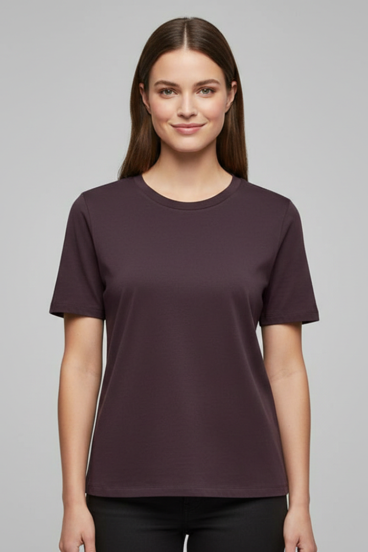 Female model wearing dark brown tee gray background