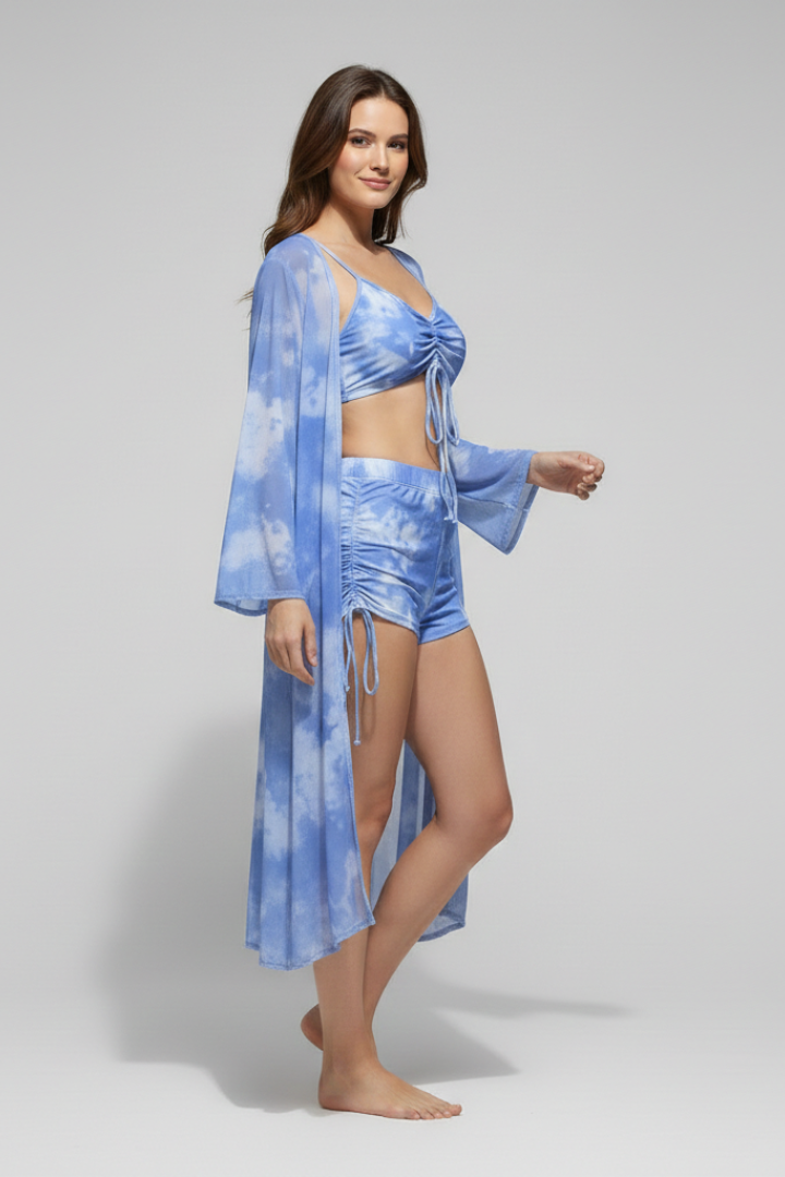  Female model in a three-piece swimsuit featuring a printed bikini and lightweight cover-up on a plain background.