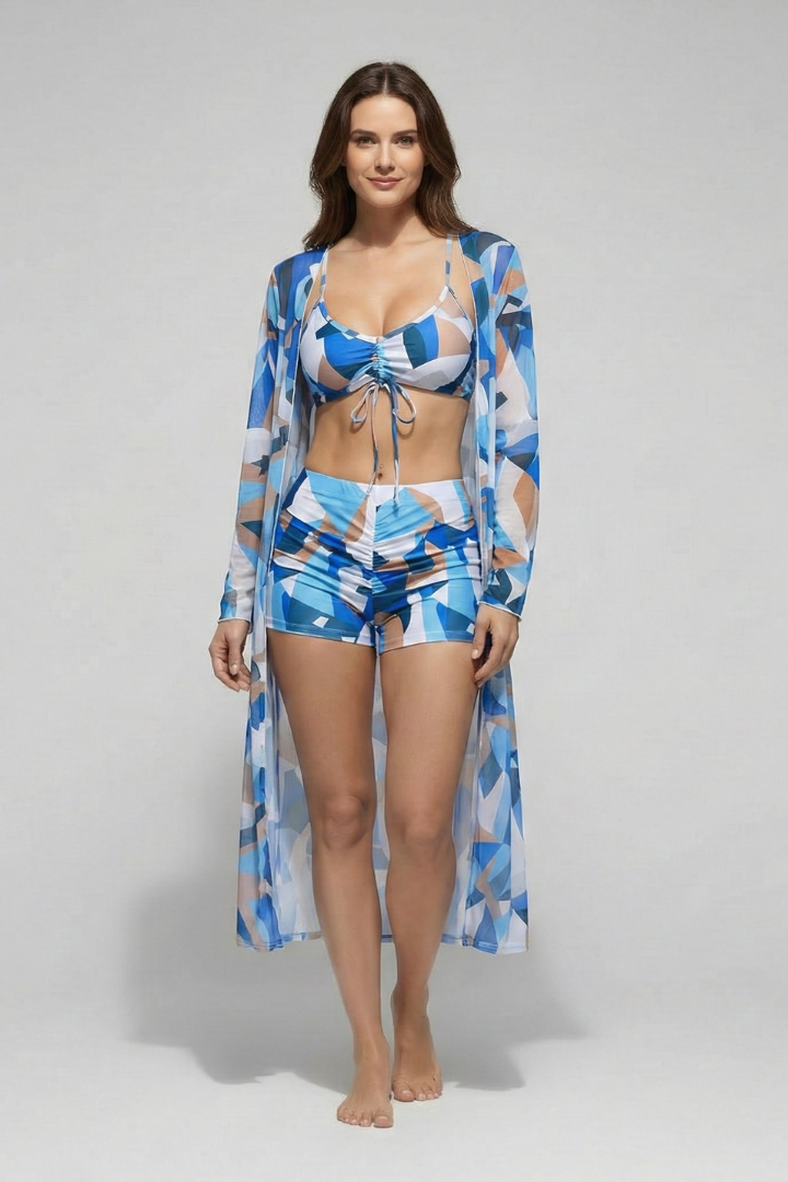 Female model displaying a stylish three-piece swimwear outfit with matching printed pieces on a plain background.