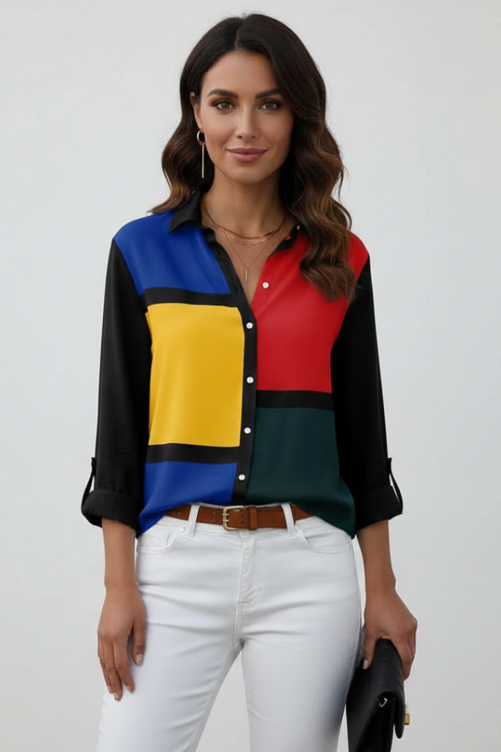 Model with clutch in multicolor blouse studio pose