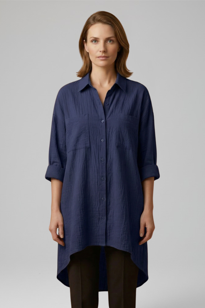 Lady in collared top with woven texture and buttons with grey background