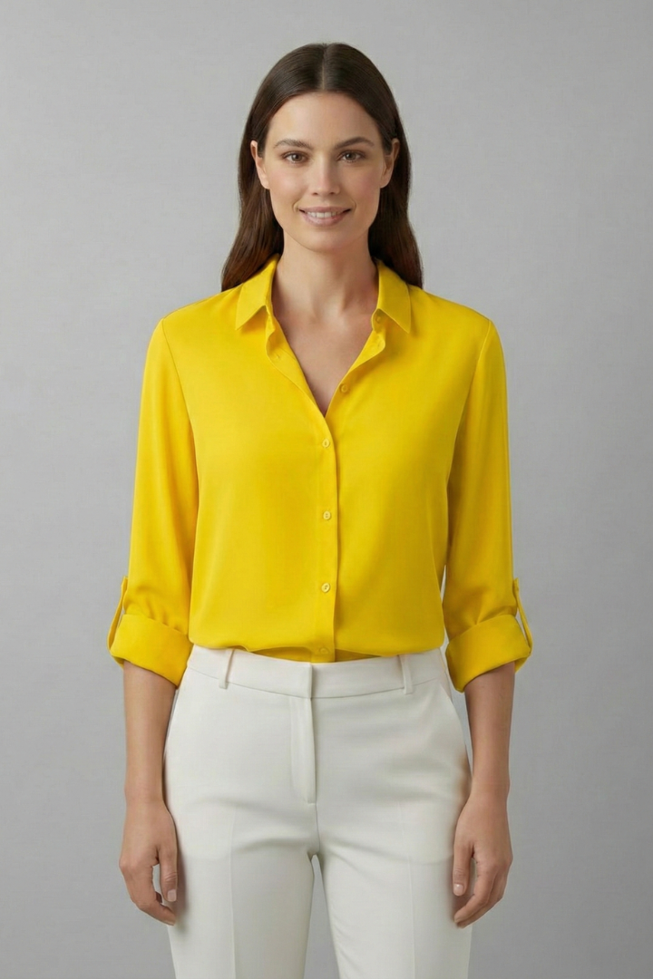Model wearing bright yellow long sleeve top with open collar