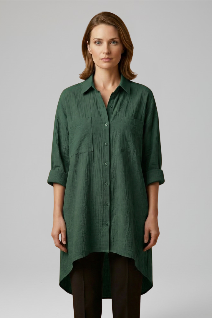 Simple woman wearing fashion green blouse on grey studio background