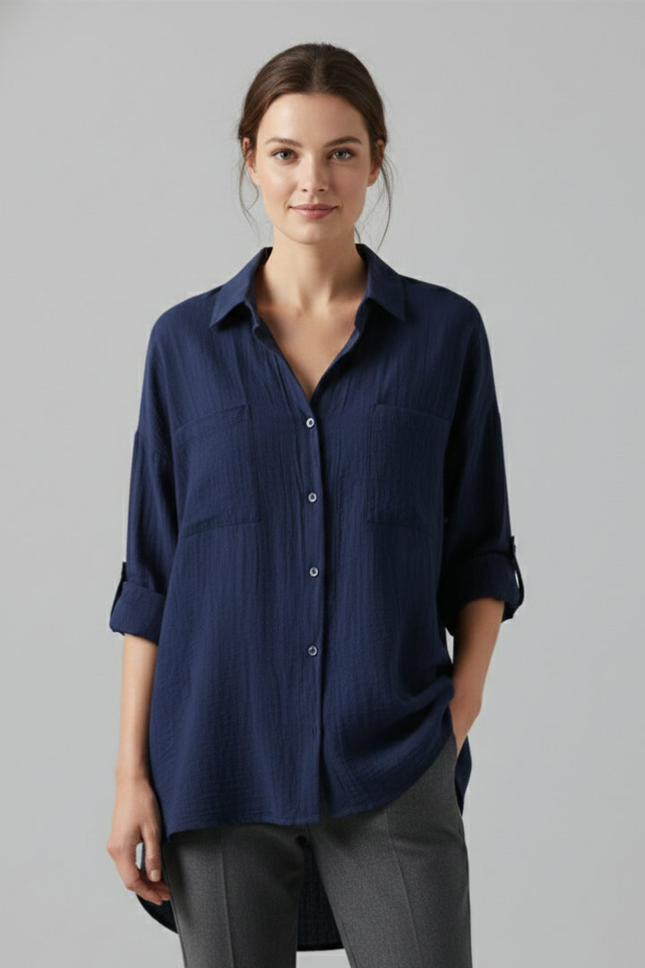 Front view female model in collared blue blouse on gray background