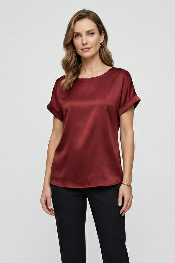 Women wearing silky burgundy blouse studio front pose