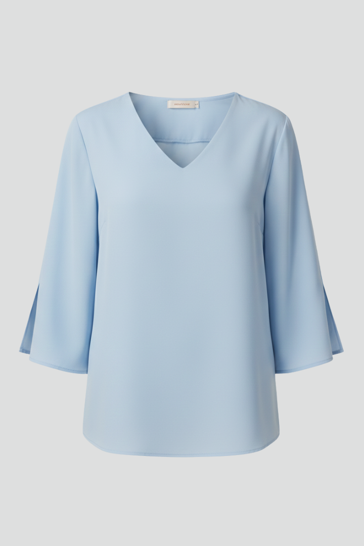 Simple elegant blouse displayed front on white backdrop