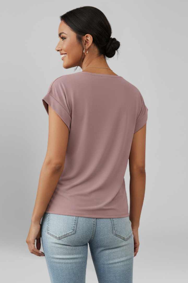 Back view of short sleeve pink blouse white background