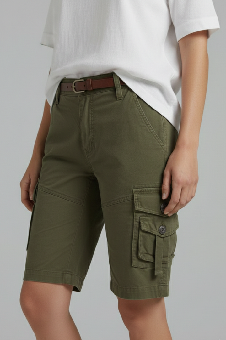 Side standing in green shorts gray background