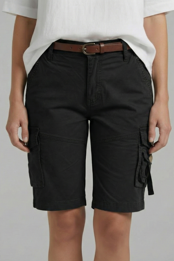 Woman wearing stitched hem shorts in gray background