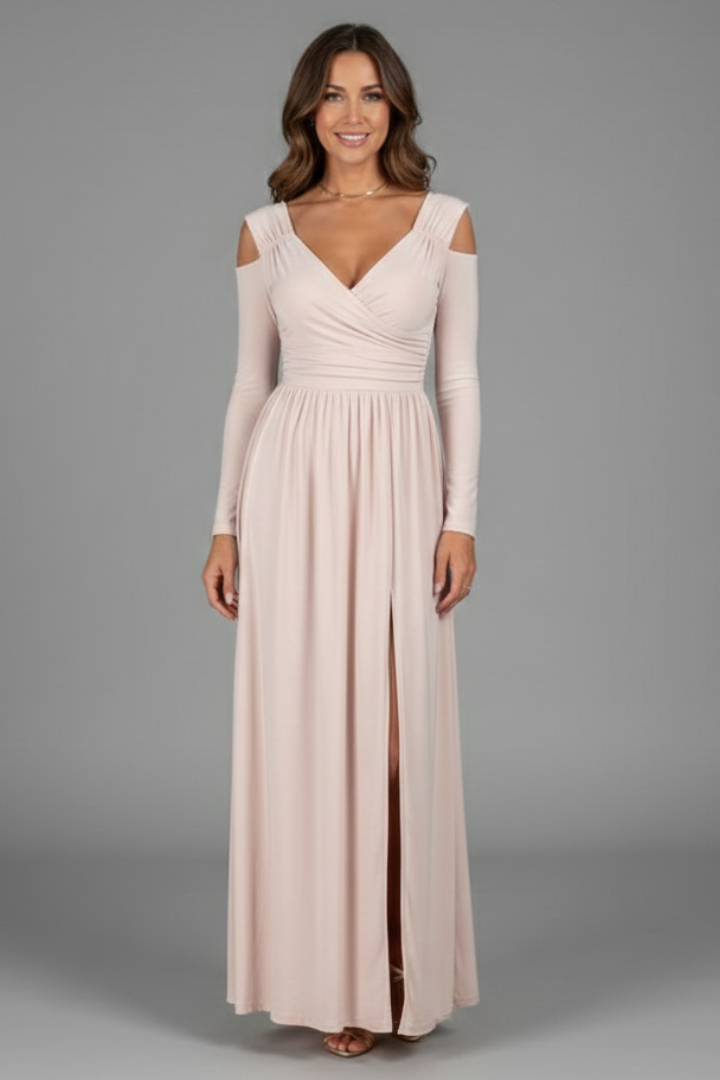 Smiling female model in long sleeve white dress in plain background