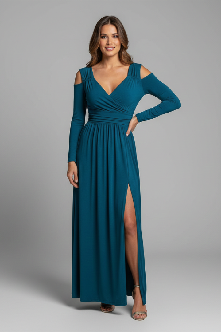 Model posing with side slit wearing the cutout dress in gray background