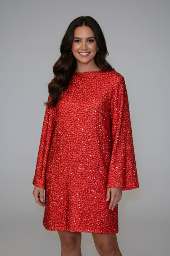 Woman posing side angle in sparkling party dress.