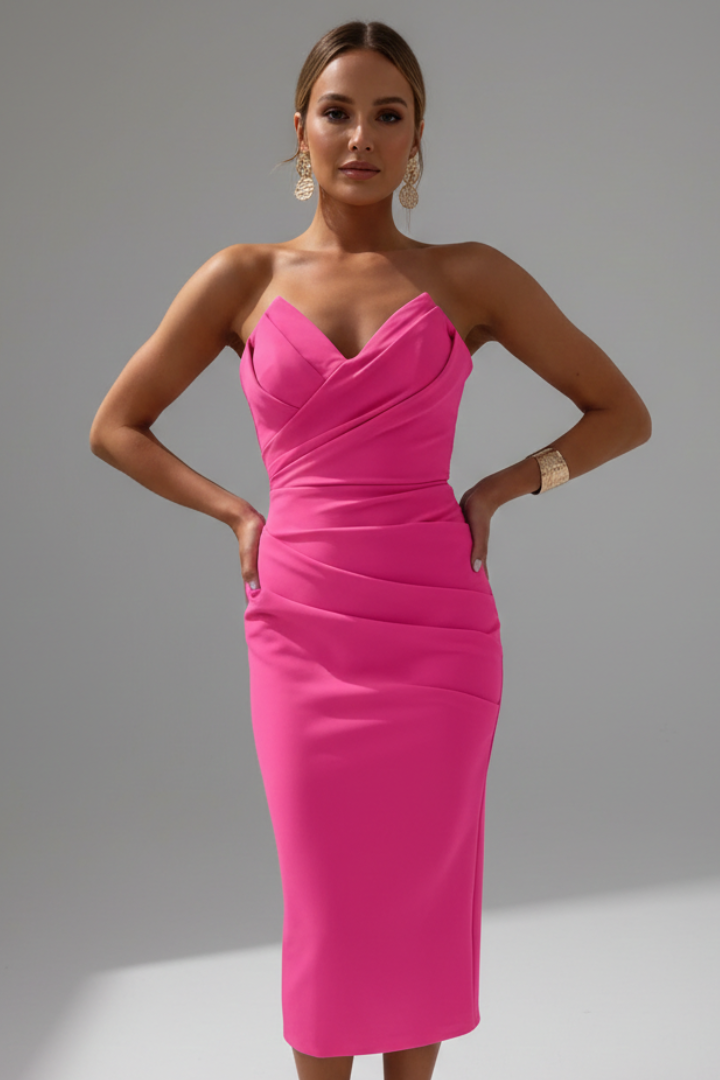 Model wearing sleek midi pink dress front pose