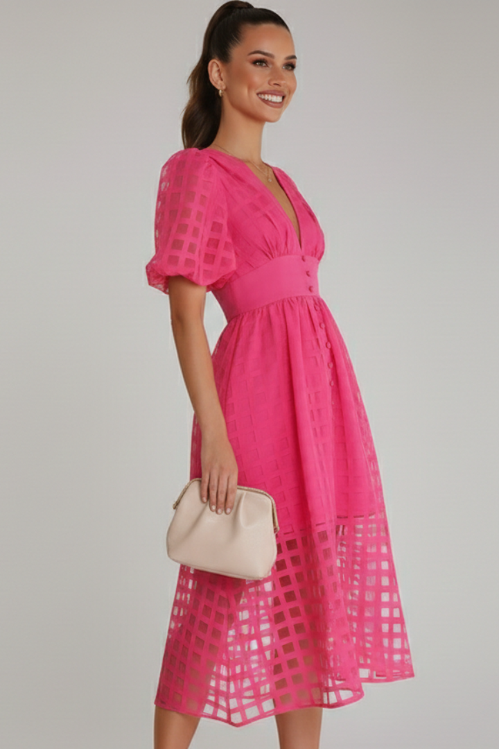 Woman with clutch posing in lace dress side angle gray
