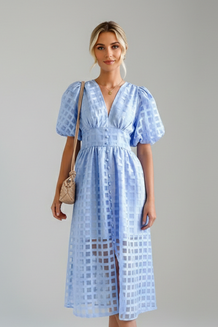 Model wearing midi blue dress with puff sleeves