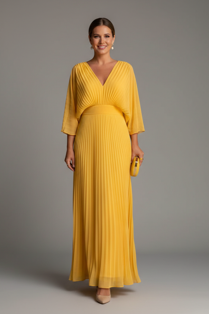 Female model wearing a polished skirt styled with a tucked top on a plain background.