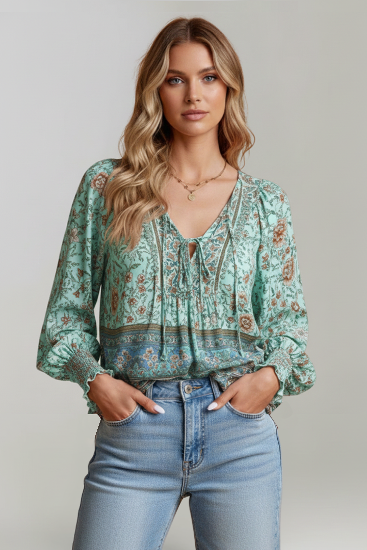 Front portrait of model wearing green long sleeve floral printed top pair with jeans