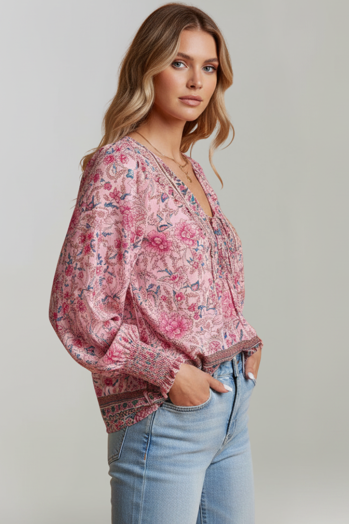 Woman side view pink floral printed top with tie neckline