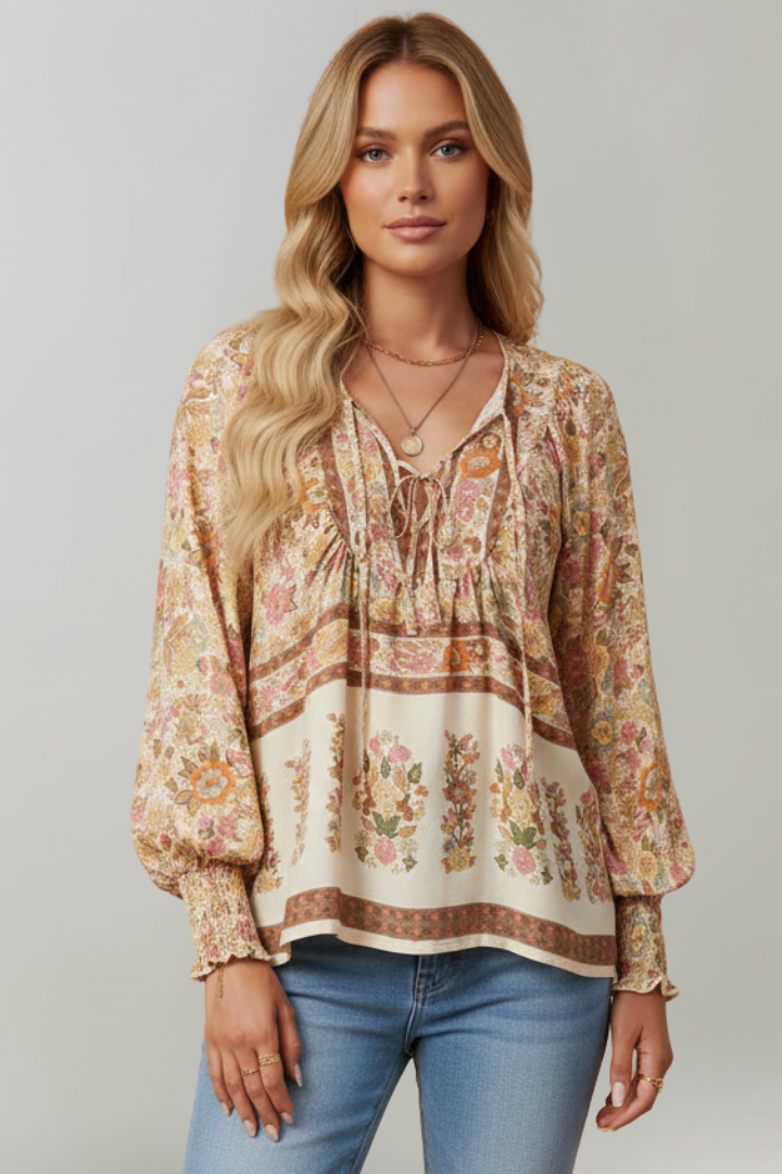Model wearing flowy brown khaki floral blouse front pose