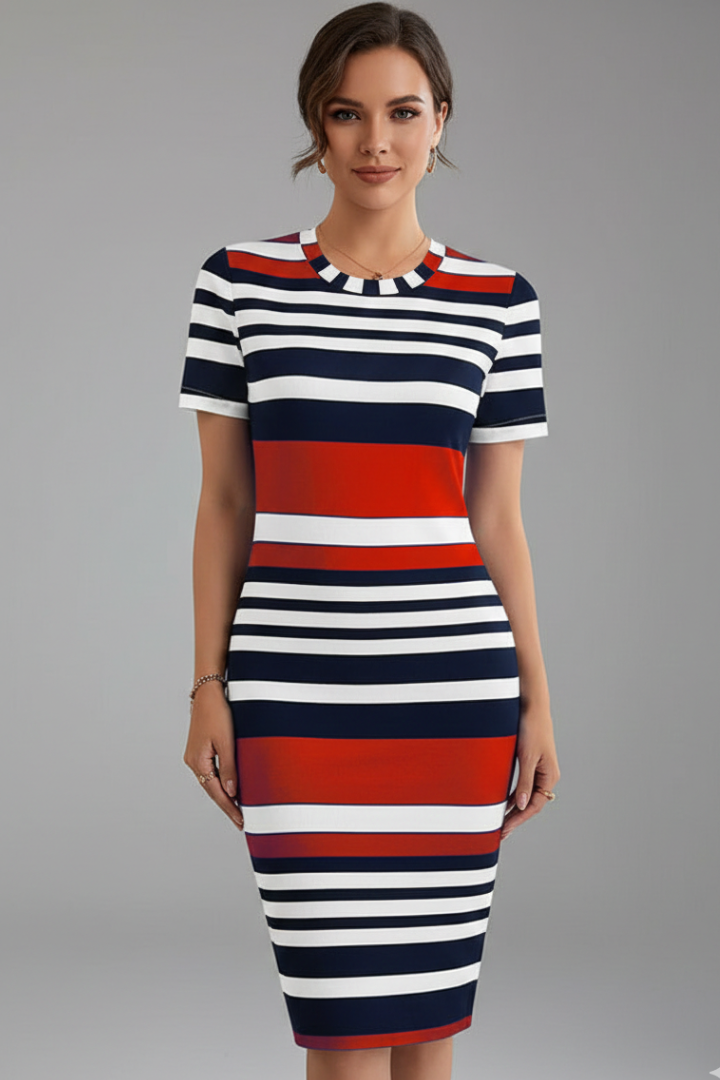 Woman wearing striped fitted dress front view on plain gray background.