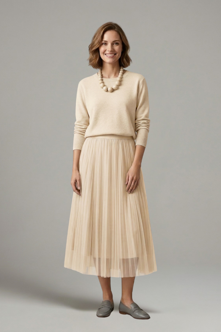 Woman in pleated dress front detail gray background