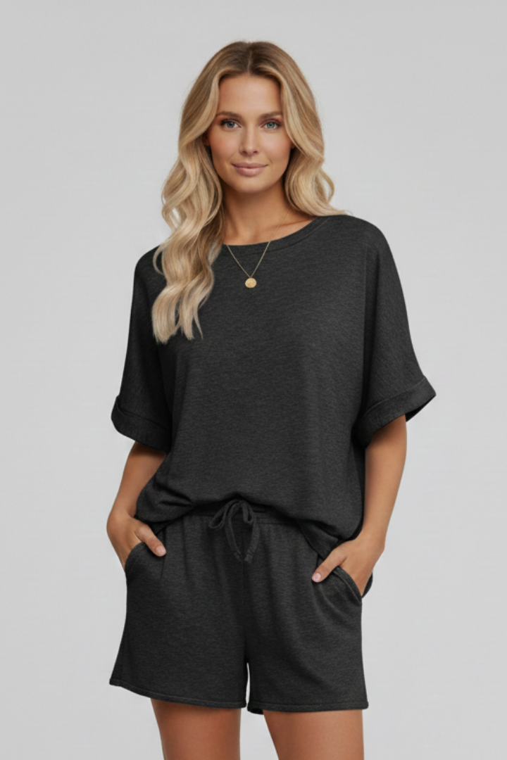 Female model in black two piece set with pockets displayed