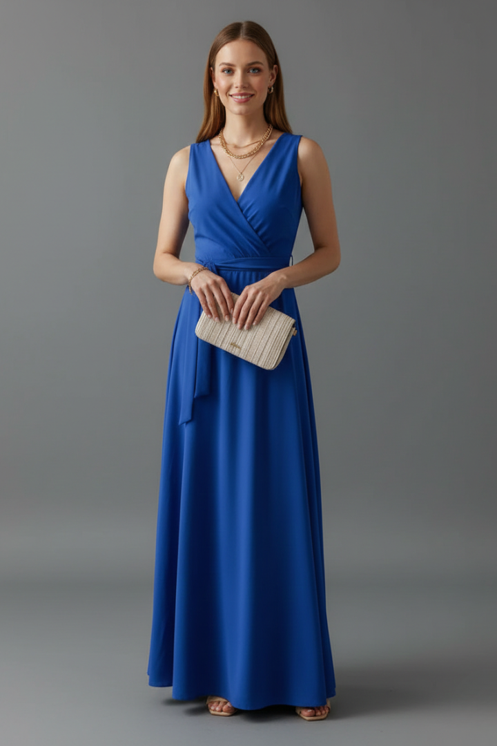 Woman wearing full-length sleeveless outfit with waist tie closure.