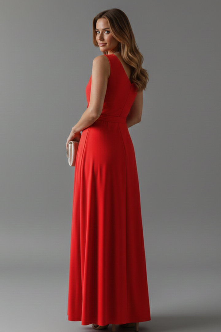 Woman showing V-neck long dress with waist tie, gray background.