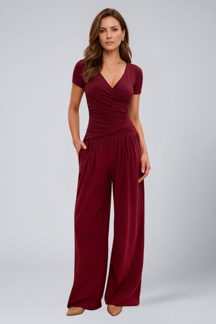Female model wearing a wrap V-neck top with wide-leg lounge pants on a plain background.