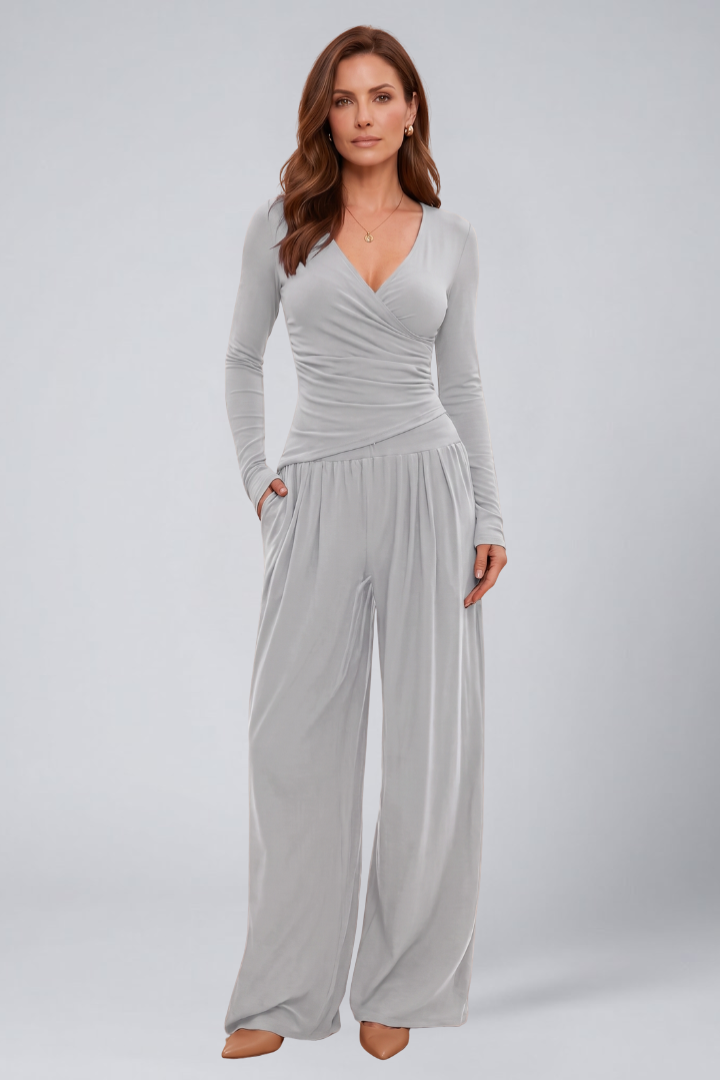 Woman dressed in a coordinated casual outfit with elastic waistband pants on a plain background.