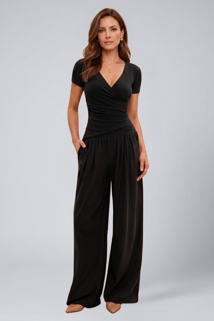 Female model in a casual matching set featuring wide-leg pants and short sleeves on a plain background.