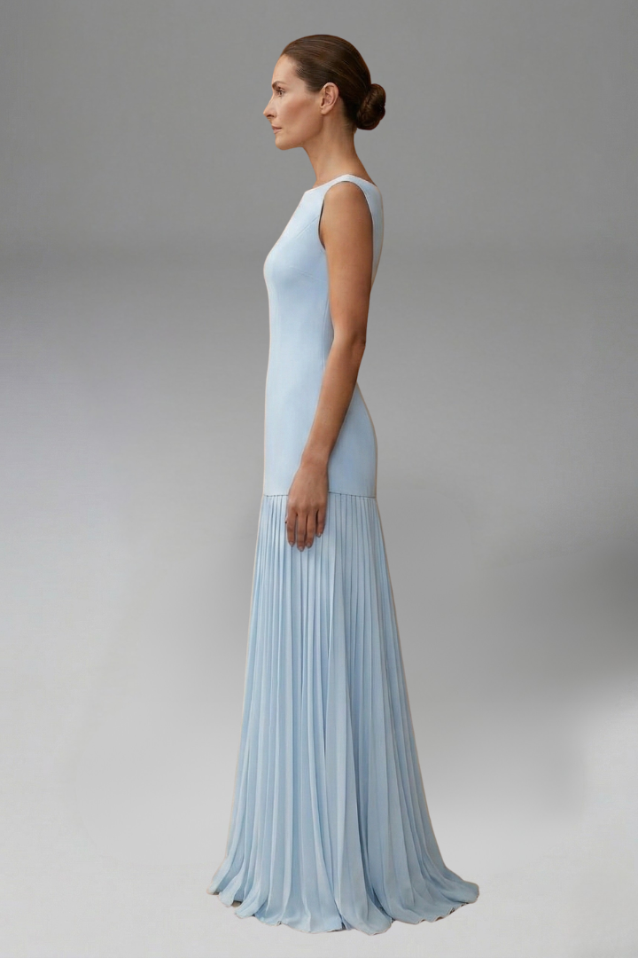 Female posing in voluminous midi skirt in side angle, gray background