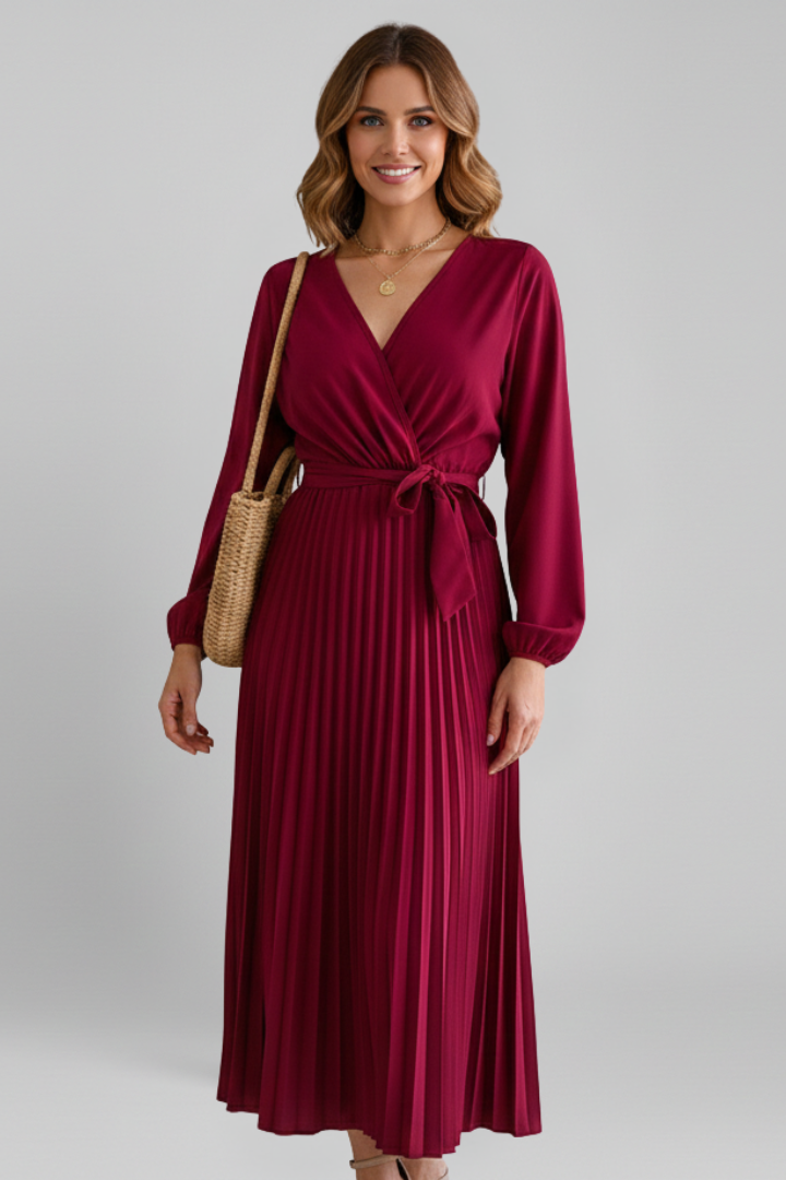 Front view of elegant pleated dress on female smiling model