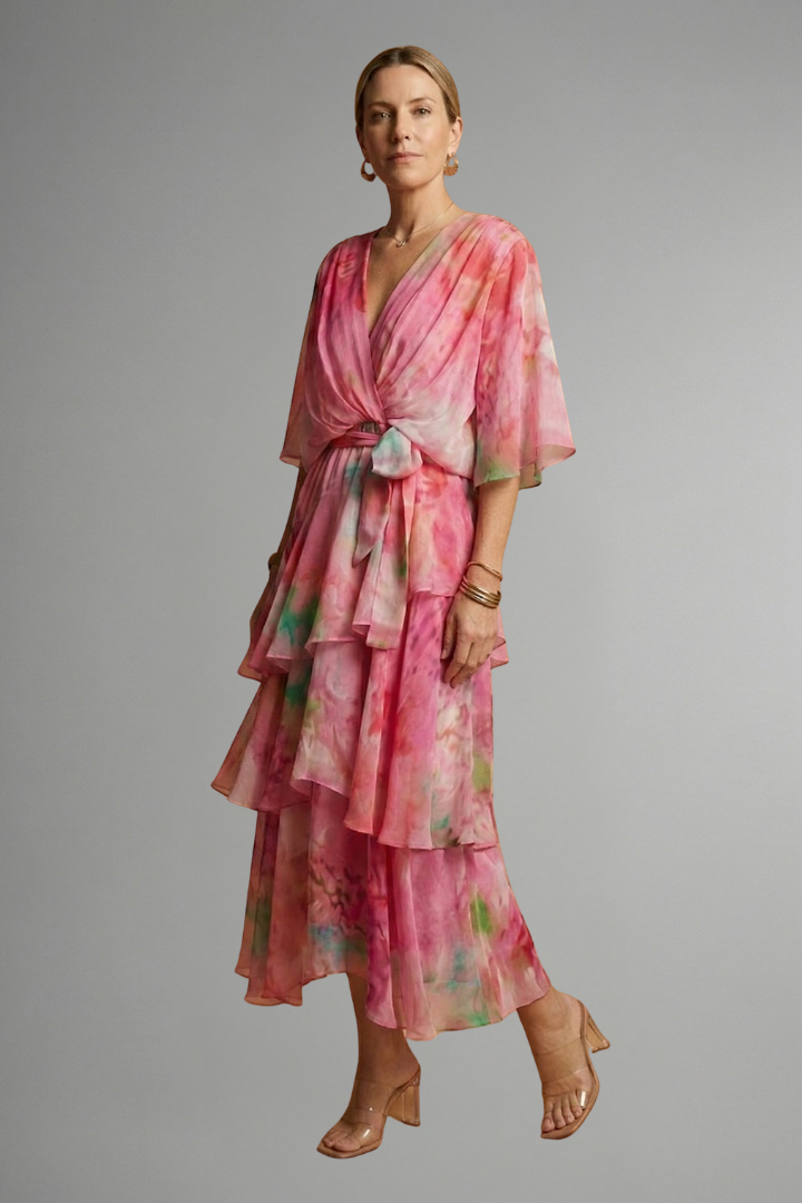 Full length printed pink dress front pose with gray backdrop
