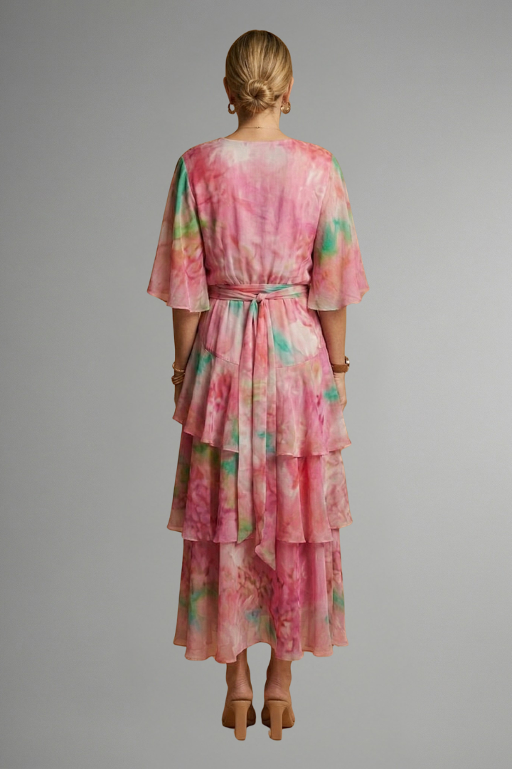 Back angle view model showing rear profile of printed maxi dress